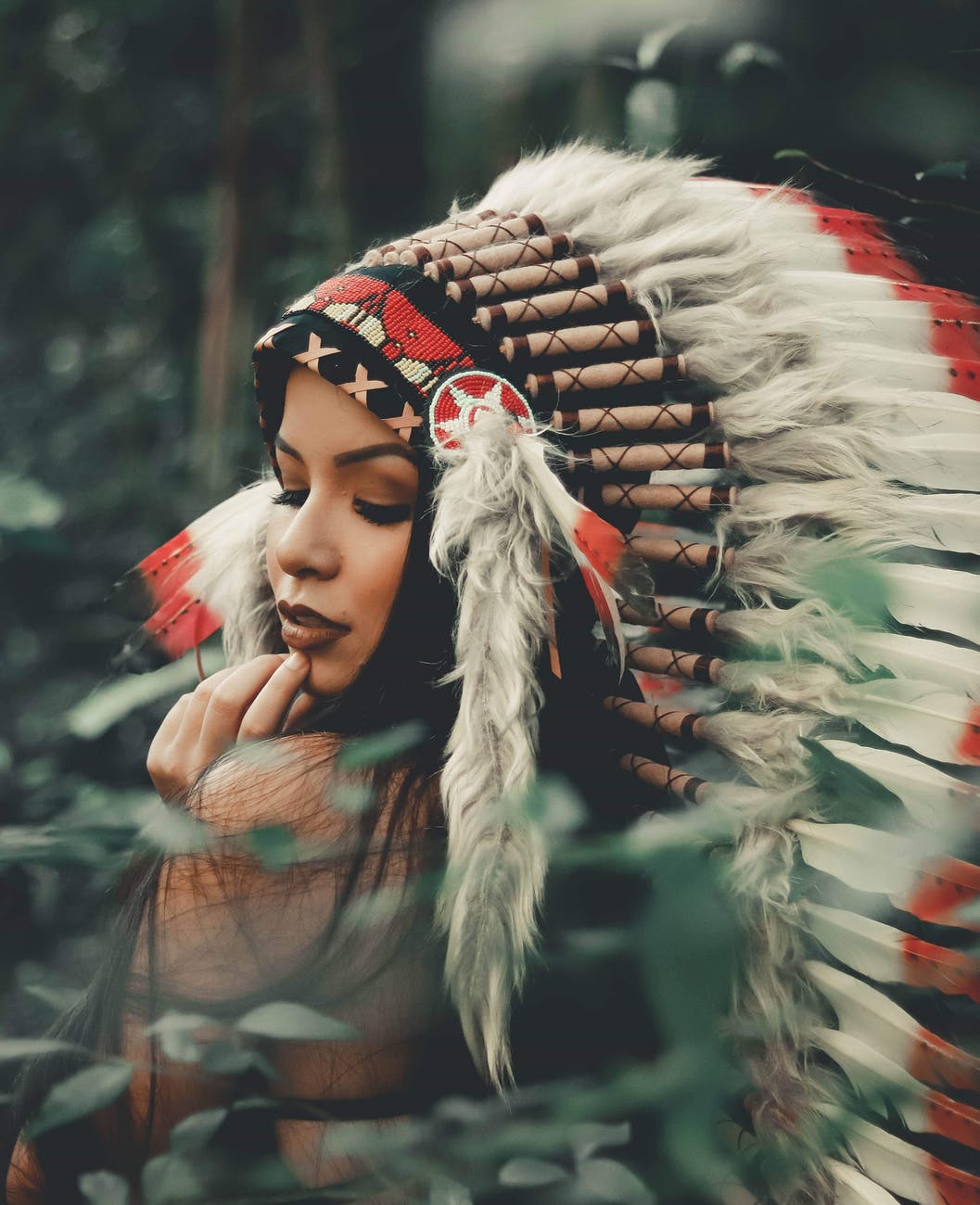 selective focus photography of woman wearing native american headdress
