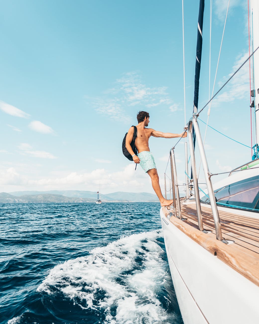man standing on the edge of boat