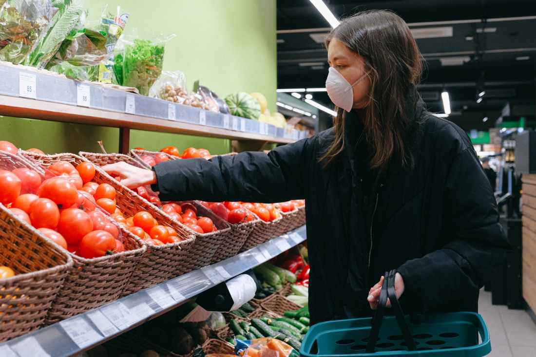 woman in face mask shopping in supermarket