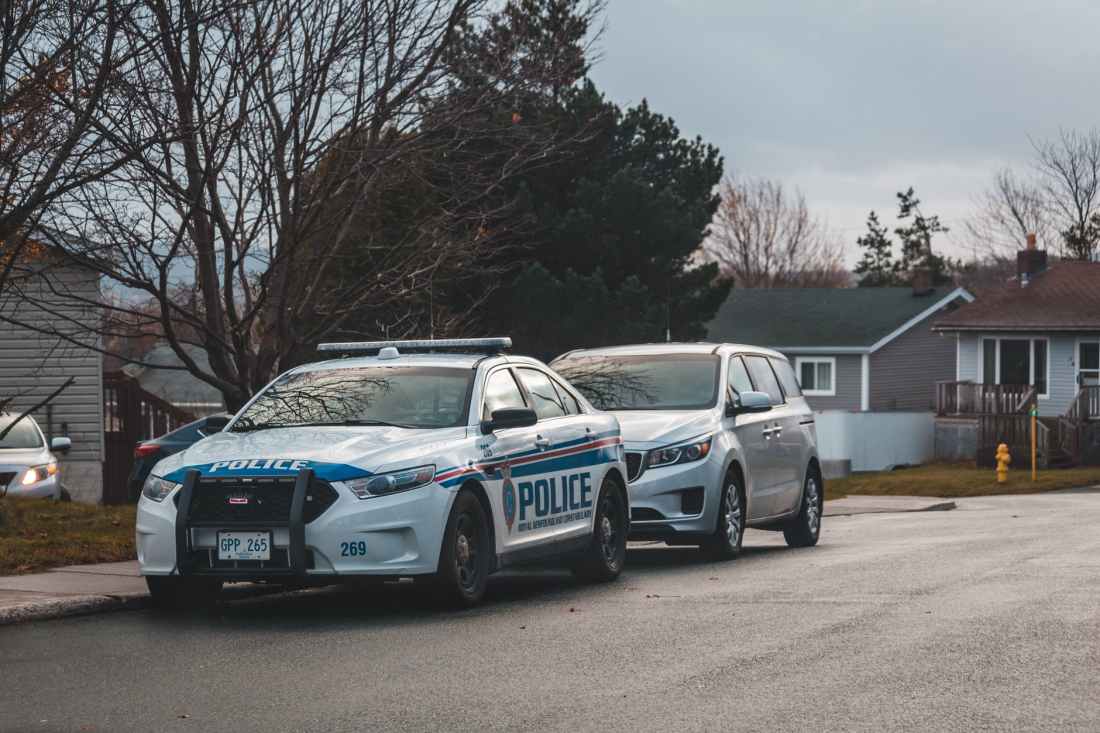 blue and white police car on road