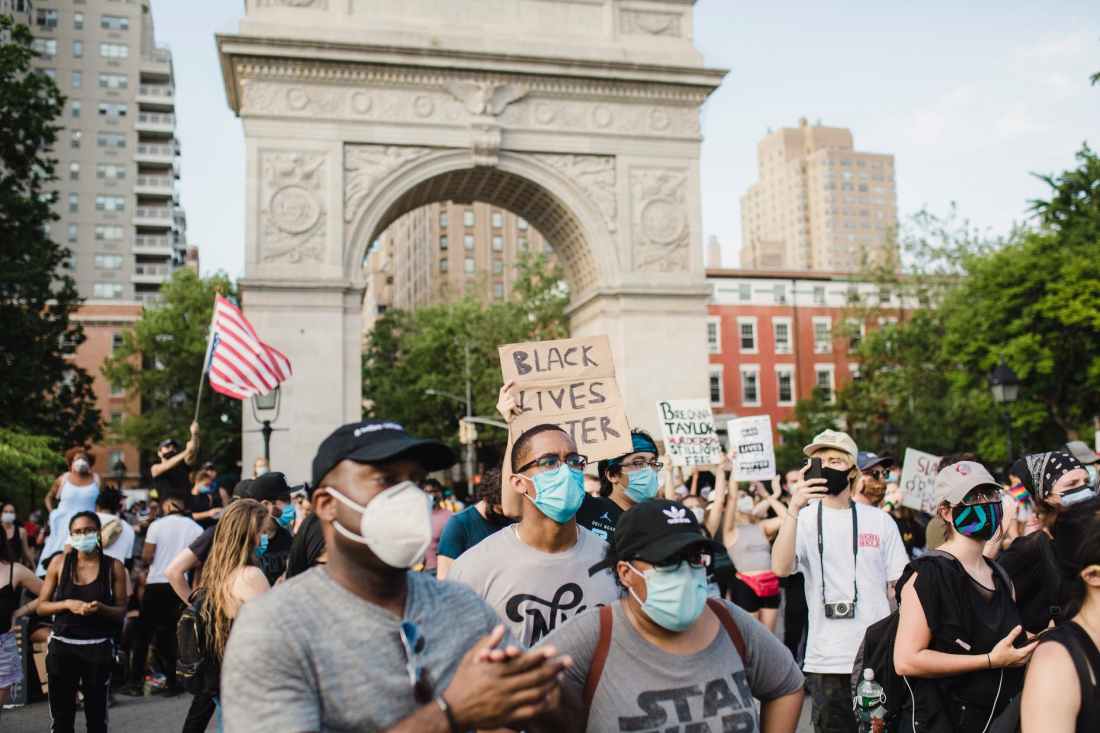 crowd of protesters holding signs