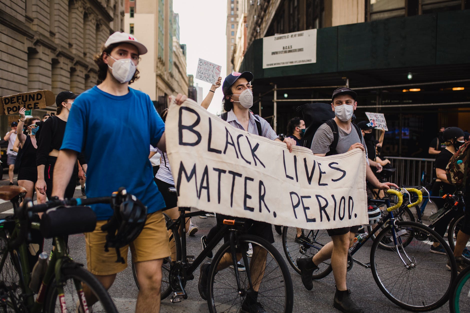 crowd of protesters holding signs